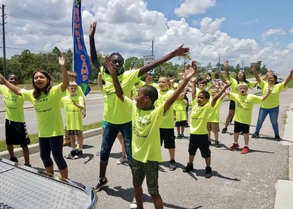 Students doing jumping jacks